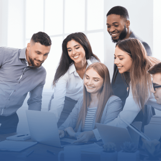 Professionals collaborating in an office using AI tools, showcasing real-world application of AI skills and the value of AI certification in today’s workforce.